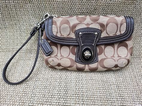 coach wristlet with shoulder strap.